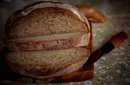 round bread, lying on a brown, wooden board