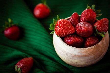 strawberry berries, red and ripe, on a green background, made of knitted fabric, with a place for copying, and a place for textの写真素材