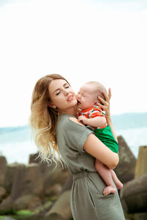 mother and baby are standing on the beach, a summer dayのeditorial素材