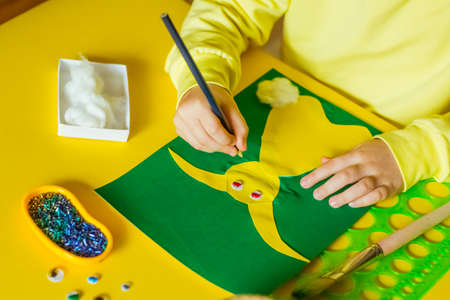 step by step instructions, colored paper application, Easter bunny, made by children's handsの写真素材