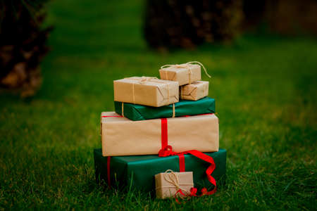 gift gifts, in craft pagift gifts, in craft paper, on the grass with space for copying, isolateper, on the grass with space to copyの写真素材