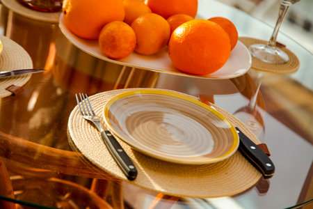 A plate with appliances.fork and knife,on a glass table,close-upの写真素材