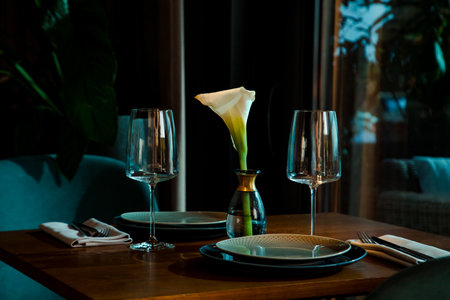 Stylish table setting in a cozy restaurant with dishes and furniture