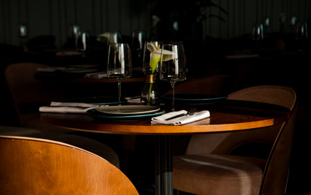 Stylish table setting in a cozy restaurant with dishes and furniture