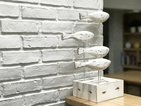 Wooden fish for decorate on white brick wall - imageの写真素材