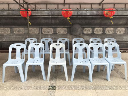 Empty plastic chair with chinese lantern in templeの写真素材