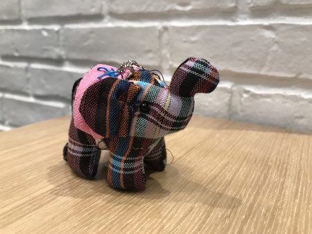 Elephant keychain in Thai style with white brick backgroundの写真素材