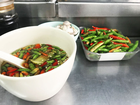 Fish sauce with chilli and cup of garlic on the tableの写真素材