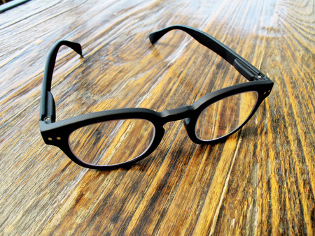 Eyeglasses on wood tableの写真素材