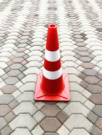 Traffic cone on a brick floorの写真素材