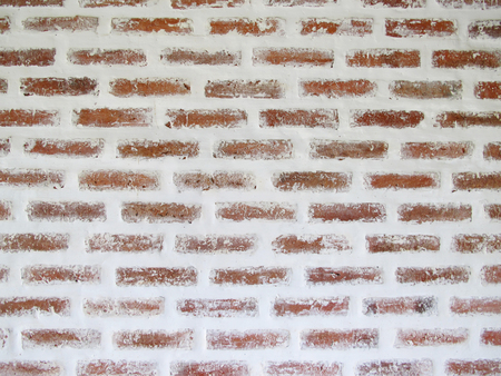 Red brick wall old vintage with peeling plaster background textureの写真素材