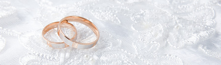 Wedding rings on wedding card on a white background, border design panoramic bannerの写真素材