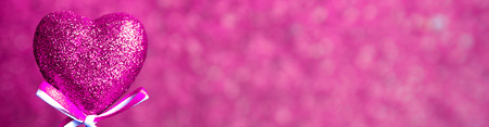 Valentines day. Pink hearts on pink blurred background closeup with copy space for congratulation, border design panoramic bannerの写真素材
