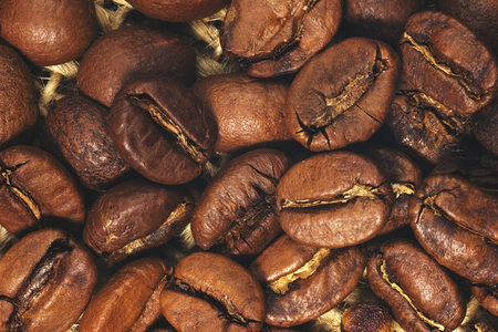 Coffee beans closeup on natural texture. Vintage tonedの写真素材