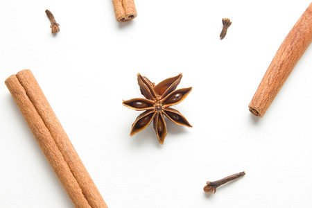 Set of cinnamon, clove and star anise, scattered in a chaotic manner, isolated on white backgroundの写真素材