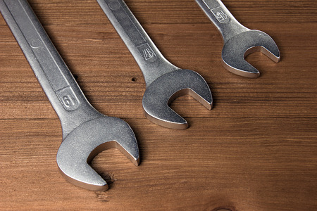Set of wrenches. Wrenches in several different sizes on natural wooden background.の写真素材