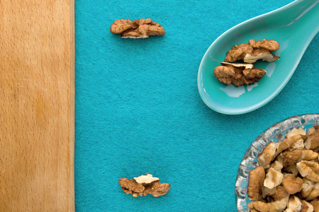 Walnuts. Top view of wooden Board and blue background. For kitchen and menuの写真素材
