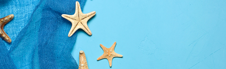 Marine blue background with seashells and starfish in fishing nets with place for your text, border design panoramic bannerの写真素材