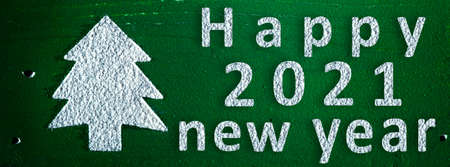 Christmas tree from snow on green background. Happy new year 2021 background. Panoramic banner.の写真素材