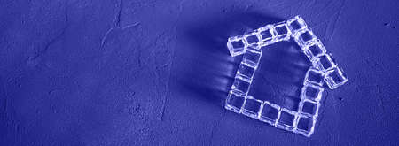 House made of ice cubes on a Purple background, the concept of real estate, border design panoramic...
