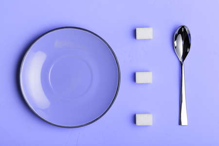 Spoon saucer and sugar cubes on Purple background, the view from the top with place for your text. concept food photos. Trendy Toned in Color of the year 2022, Very Peri.の写真素材