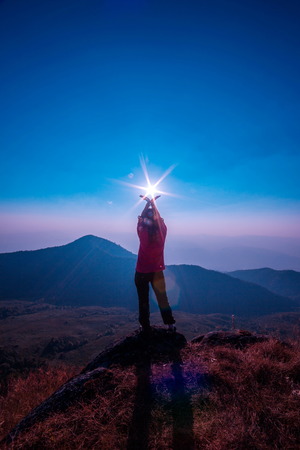 Silhouette of person standing on one leg and meditating