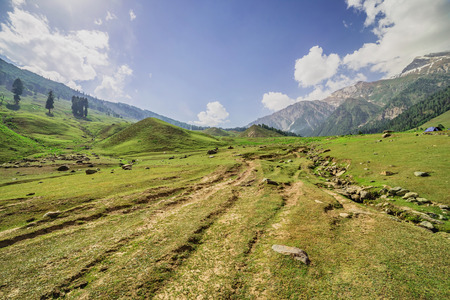 Mountains meadows surrounded with sky and cloudの写真素材