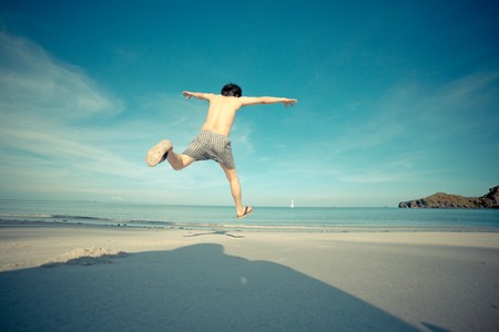 Man jump on the beach. Concept of a happiness lifeの写真素材