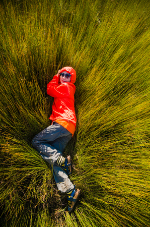 Girl lying on the grassの写真素材
