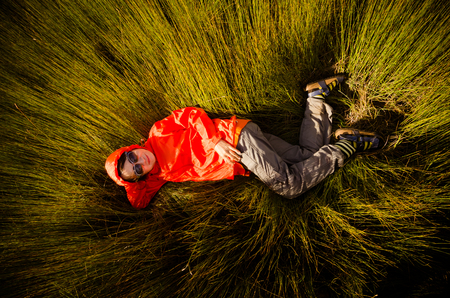 Girl lying on the grassの写真素材