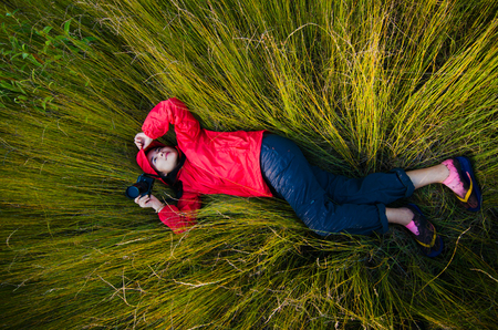 Girl lying on the grassの写真素材