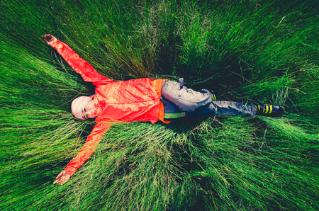 Girl lying on the grassの写真素材