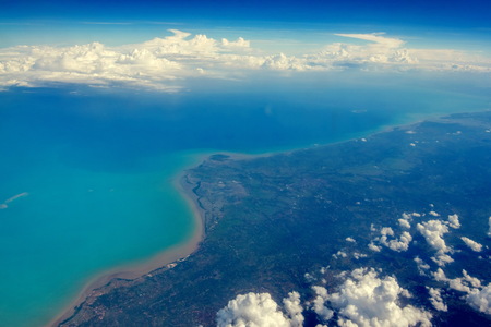 View of cloudscape and airplane wing during air travelの写真素材
