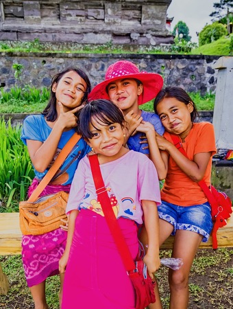 BESAKIH TEMPLE, BALI, INDONESIA-AUGUST 13 : Unidentified girls posing for tourists at theBesakih temple on August 13, 2016 in Bali, Indonesia. Besakih temple is one of the most famous hindu temple in Bali islandのeditorial素材