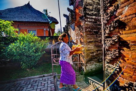 UBUD, BALI, INDONESIA - AUGUST 13: Unidentified local women wearing in traditional indonesian clothes take part in Buda Wage Kelawu ceremony at Hindu temple on August 13, 2016 in Ubud, Indonesia.のeditorial素材
