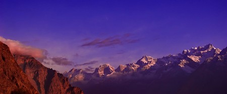 beautifull cloudy sunrise in the mountains with snow ridgeの写真素材