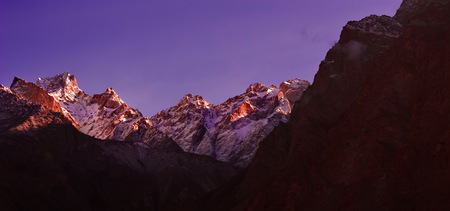 beautifull cloudy sunrise in the mountains with snow ridgeの写真素材