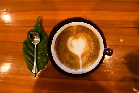 hot cappuccino on wooden tableの写真素材