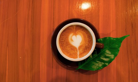 hot cappuccino on wooden tableの写真素材