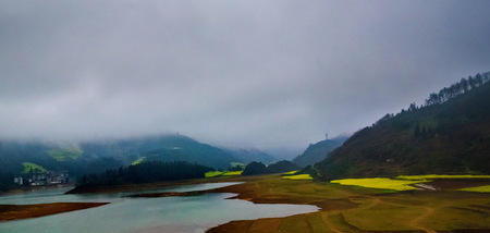 Canola field, rapeseed flower field with the mist in Luoping, Chinaの写真素材