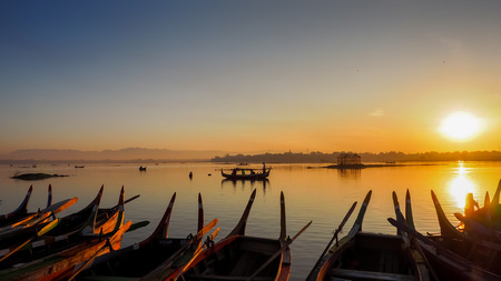 Sunrise in U Bein bridge with vintage boat, Myanmar. U Bein bridge is longest teakの写真素材