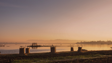 Life of fisherman at river side in Mandalay, Myanmar with wonderful sun light at morningの写真素材