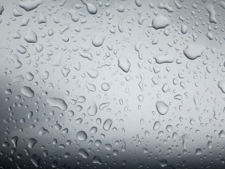 Water Drop on the Hood of the Car. Rain Drops on the Surface of the Car or on the Iron Surface Flow Down. Abstract Background and Water Texture for Design.の写真素材