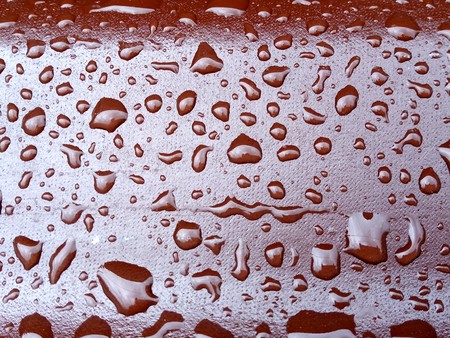 Rain Drops on the Surface of the roof tile or on the Iron Surface Flow Down. Abstract Background and Water Texture for Design.の写真素材