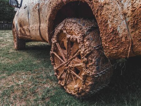 Detailed view of motion the wheels tires and off-road truck shaft that goes in the and mud through...