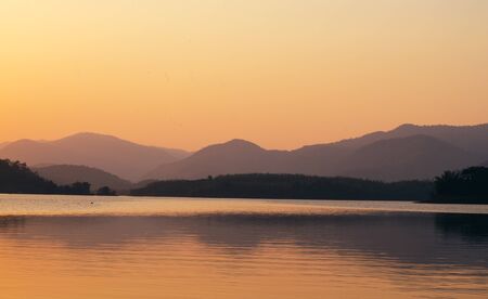 sunset sunrise over river and mountainの写真素材