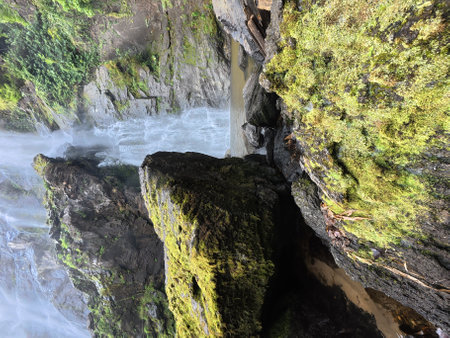 Mossy rocks and waterfall in the deep forest on the mountainの写真素材