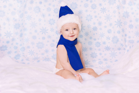 the child in a the snowman costume is against the backdrop of snowflakes.の写真素材
