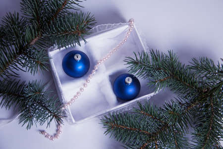 The Christmas decoration on a white background in a beautiful package. The New Year's gifts with a sprig of spruceの写真素材