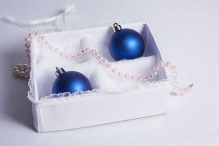 The Christmas decoration on a white background in a beautiful package. The New Year's gifts with a sprig of spruceの写真素材